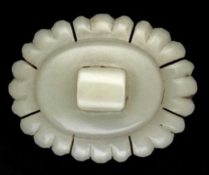 An incomplete button or ornament, fashioned in greyish green nephrite jade