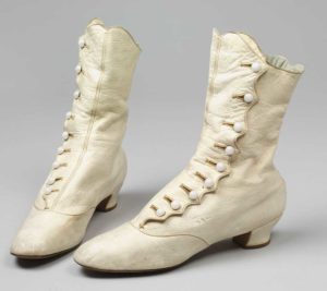 Pair of white kidskin boots with pearl buttons and medium heel